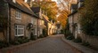 © Epic Photo - Autumnal Street Scene in a Quaint Village - Charming stone houses line a cobblestone street, bathed in the warm glow of autumn sunlight. Fallen leaves add to the picturesque scene