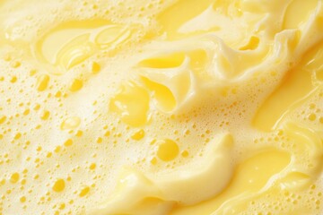 Aufkleber - Close-up of a creamy yellow liquid forming bubbles and foam, creating an abstract and textured background