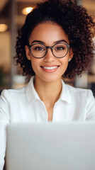 Poster - professional businesswoman smiling, working on laptop while wearing stylish glasses