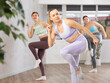 © JackF - Smiling women engaging in aerobics in light gym room during sports classes