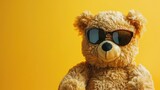 A cheerful teddy bear wearing stylish sunglasses against a vibrant yellow background, radiating warmth and fun