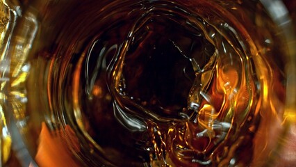 Poster - Detail of pouring whiskey into glass. Freeze motion drink preparation.