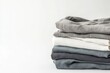 © isz - Soft Stack of Neutral Colored Folded Cotton Fabrics on White Background