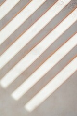 Poster - Soft sunlight casting striped shadows on a textured wall