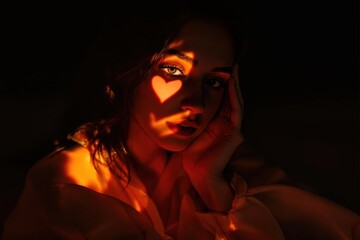Poster - Captivating portrait with warm orange light casting a heart shadow on the face