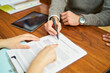 © Retamosa - Businessman signing contract with help from financial advisor