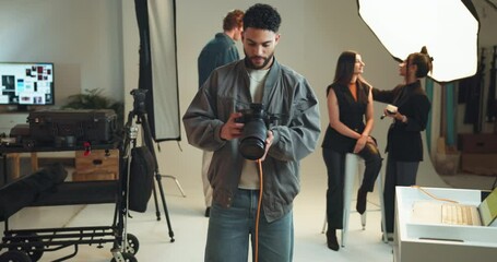 Poster - Camera, photography and smile with man on set for fashion magazine or style photoshoot. Direction, lighting or production with serious photographer behind the scenes for artistic or creative catalog