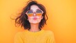 © Akash - young woman in oversized sunglasses blowing kiss with pastel orange background