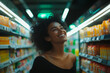© Rodrigo - A smiling Brazilian woman posing in a brightly lit supermarket. In the background there are shelves with products and a refrigerator with drinks.