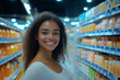 © Rodrigo - A smiling Brazilian woman posing in a brightly lit supermarket. In the background there are shelves with products and a refrigerator with drinks.