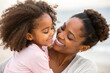 © GTNA73 - Happy afro-american mother carrying smiling hugs daughter in her arm. Closeup.