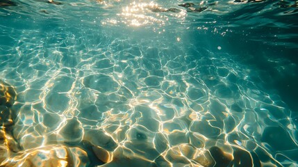Poster - Underwater view of sunlight creating rippling patterns on sandy ocean floor through crystal clear turquoise water, natural aquatic background with light rays.