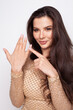 © millaf (Nemchinova) - Beautiful brunette woman pointing on her ring finger thinking about marriage