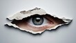 © Leo Rohmann - Conceptual image of a blue human eye looking through a torn paper hole symbolizing surveillance, hidden observation, privacy concerns, and digital security awareness