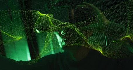 Poster - animation of digital wave patterns flowing over person in dark environment