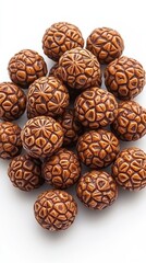 Poster - Heap of Intricate Wooden Carved Balls on White Backdrop Displaying Detailed Texture and Pattern in Warm Brown Tones Perfect for Crafting and Design