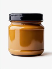 Poster - Creamy peanut butter in a glass jar with a black lid on a white background studio shot food photography