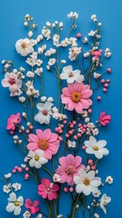 Aufkleber - A lively arrangement of pink and white flowers along with sprigs of delicate greenery creates a stunning visual contrast against a bright blue background, showcasing nature's beauty