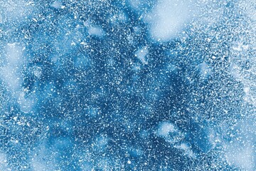 Poster - Snowflakes and ice crystals form an intricate, textured surface on a frozen lake, creating an abstract winter background with blue colors