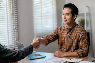 Poster - Professional businesspeople sealing partnership, exchanging handshake across sleek workspace, confirming collaborative business agreement