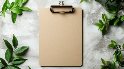 Poster - A wooden clipboard rests elegantly against a gray textured backdrop, surrounded by lush green leaves, creating a serene and inspiring workspace. Ideal for jotting down ideas and plans