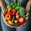 © Tom - Fresh and colorful assortment of organic vegetables and fruits held in hands showcasing healthy eating