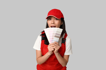 Wall Mural - female asian shocked painter with paint color palettes on grey background