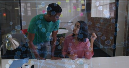 Poster - Discussing work at desk, two colleagues using animation with data visualization