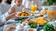 © artchvit - Ramadan feast iftar gathering celebration. Family sharing a meal with vibrant dishes and drinks on a festive table.