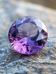 Poster - Faceted amethyst gemstone resting on textured stone surface in natural light close up shot
