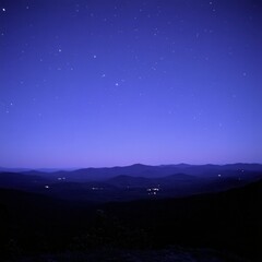Wall Mural - serene nightscape of mountain range under a star studded sky capturing distant lights and tranquil a
