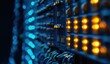 © BerkahStock - Close-up of server rack with glowing lights and cables in a dark room.