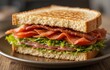 © Iqra - A classic sandwich with crispy bacon, lettuce, and tomato slices on toasted bread
