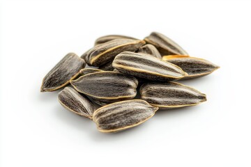Poster - Heap of natural shelled sunflower seeds on white background displaying food source and texture macro photography