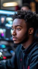 a focused young man working on a digital project in a studio environment.