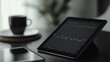 © CHRISTIANA - Tablet Displaying Stock Market Chart on a Desk with Coffee Cup