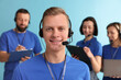 © New Africa - Technical support call center. Team of friendly operators working on light blue background
