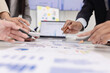 © SOMKID - Group of business people working together with marketing strategy analysis at meeting room, Business technology in boardroom for training marketing concept.