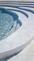 Poster - A close-up view of circular stone steps leading into a clear blue pool, showcasing geometric patterns and smooth textures