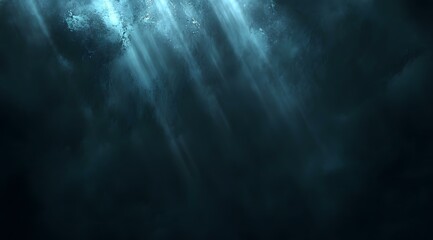 A dark, grainy abstract texture featuring a soft, glowing blue light effect. The diffused illumination seamlessly blends into the surrounding shadows, creating a mysterious and futuristic atmosphere