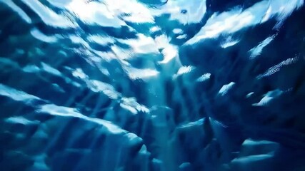 Poster - Sunlight streaming through blue ocean water creating wave patterns, underwater world