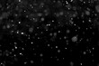 © kulkann - Texture of natural falling snow on black background.