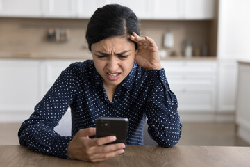 Unexpected problem. Outraged shocked nervous young lady modern mobile phone user look at screen confused with scam message text get device broken lose information after catching virus malware program