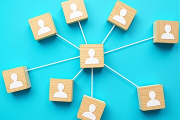 Poster - Wooden blocks with human icons connected by white lines on a blue background.