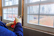 © ungvar - Contractor is sealing gaps around window frame with insulation foam during home renovation project