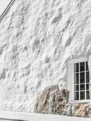 Poster - Textured white stucco wall with window and stone foundation in minimalist architectural style