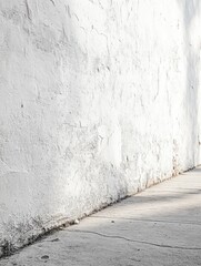 Poster - Textured White Wall and Concrete Sidewalk with Sunlight Casting Shadows in Urban Setting for Backgrounds