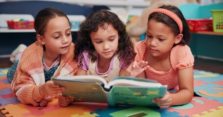 Leinwandbilder - Education, happy and children with book in classroom for learning, development or story time. Friends, relax and girl students reading novel on floor mat for literacy knowledge at elementary school.