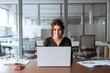 © Stock 4 You - Smiling 30s latin hispanic middle-aged business woman working on laptop computer in modern office. Indian young businesswoman professional employee using pc doing online banking analysing at workplace