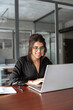 © Stock 4 You - Concentrated latin hispanic middle-aged business woman working on laptop computer in modern office. Indian young businesswoman professional employee using pc doing online banking analysing. Vertical